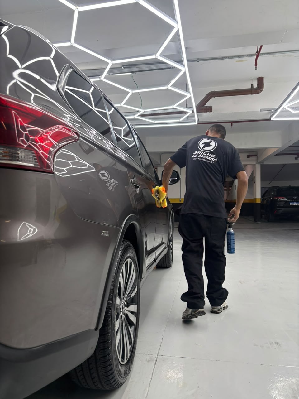 Profissional da Brilho Relâmpago cuidando da carroceria de um carro